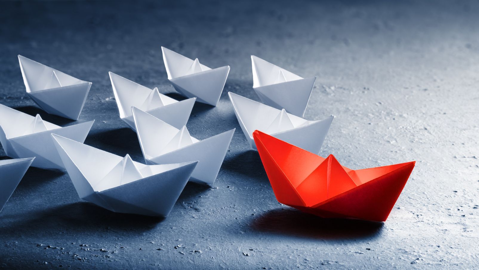 Hvite origami bak en rød rigami